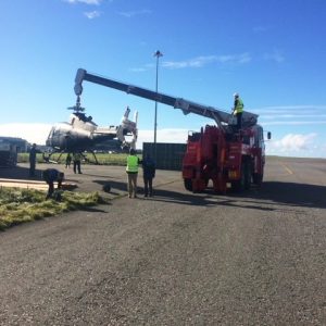 Helicopter being lifted by crane