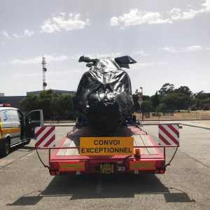 Helicopter being transported on low loader